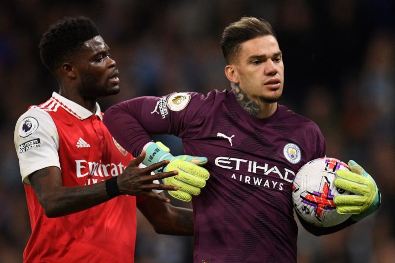 Manchester City's Brazilian goalkeeper Ederson (R) refuses to return the ball to Arsenal's Ghanaian midfielder Thomas Partey after conceding a goal during the English Premier League football match between Manchester City and Arsenal at the Etihad Stadium in Manchester, north west England, on April 26, 2023.  (Photo by OLI SCARFF/AFP via Getty Images)