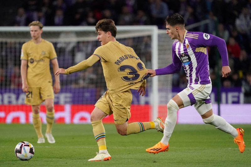 Barcelona's Spanish midfielder Pablo Torre (L) fights for the ball with Real Valladolid's Spanish defender Ivan Fresneda during the Spanish league football match between Real Valladolid FC and FC Barcelona at the Jose Zorilla stadium in Valladolid on May 23, 2023. (Photo by CESAR MANSO/AFP via Getty Images)