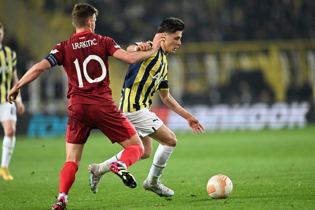 Fenerbahce's Turkish midfielder Arda Guler (R) vies for the ball with Sevilla's Croatian midfielder Ivan Rakitic (L) during the UEFA Europa League last 16 second leg football match between Fenerbahce SK and Sevilla FC at the Fenerbahce Ulker stadium in Istanbul on March 16, 2023. (Photo by OZAN KOSE/AFP via Getty Images)