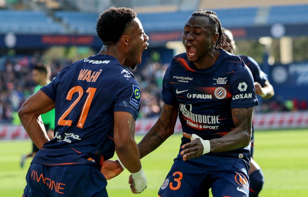 Montpellier's French forward Elye Wahi (L) celebrates with Montpellier's Guinean defender Issiaga Sylla after he scored his team's first goal during the French L1 football match betwen Montpellier Herault SC and Clermont Foot 63 at the mosson stadium in Montpellier, southern France, on March 19, 2023. (Photo by Pascal GUYOT / AFP) (Photo by PASCAL GUYOT/AFP via Getty Images)