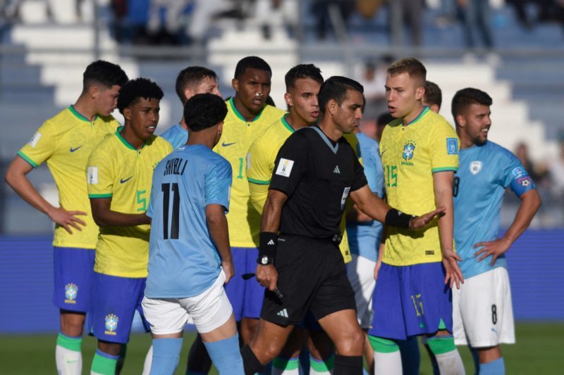 Players of Brazil argue with Costa Rica's referee Juan Gabriel Calderon as he awards a penalty-kick to Israel during extra-time of the Argentina 2023 U-20 World Cup quarter-final football match between Israel and Brazil at the San Juan del Bicentenario stadium in San Juan, Argentina, on June 3, 2023. Israel on 3-2. (Photo by ANDRES LARROVERE/AFP via Getty Images)