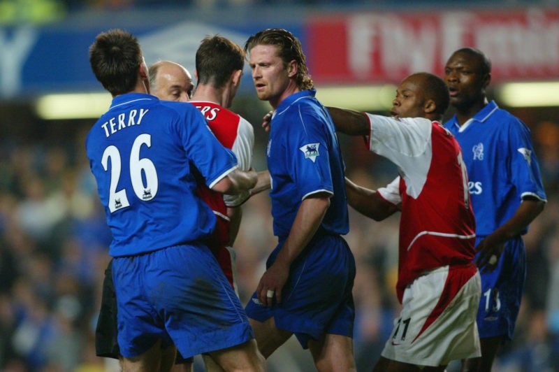 LONDON - MARCH 25: Francis Jeffers of Arsenal goes head to head with Emmanuel Petit of Chelsea during the FA Cup Quarter Final Replay match between Chelsea and Arsenal at Stamford Bridge in London on March 25, 2003. (Photo By Ben Radford/Getty Images)