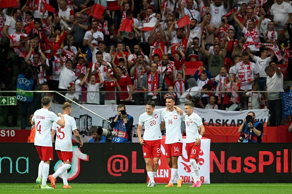 WARSAW, POLAND: Jakub Kiwior of Poland celebrates with teammates after scoring their side's first goal during the international friendly match between Poland and Germany at Stadion Narodowy on June 16, 2023. (Photo by Rafal Oleksiewicz/Getty Images)