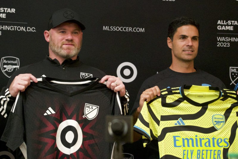 Wayne Rooney (L), Major League Soccer (MLS) All Stars Coach and current DC United Coach, and Arsenal manager Mikel Arteta hold up jerseys as they pose for a photo during a news conference in Washington, DC, on July 18, 2023. The MLS All Stars will play a friendly match against English Premier League's Arsenal FC on July 19, 2023. (Photo by BASTIEN INZAURRALDE/AFP via Getty Images)