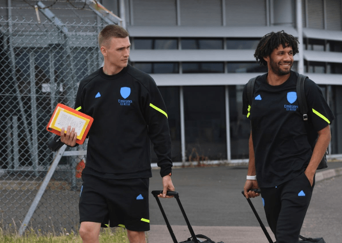 LUTON, ENGLAND: Runar Alex Runarsson and Mo Elneny of Arsenal board the team flight to Germany at Luton Airport on July 09, 2023. (Photo by Stuart MacFarlane/Arsenal FC via Getty Images)