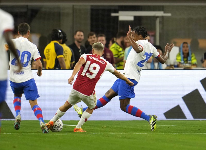 INGLEWOOD, CALIFORNIA - JULY 26: Leandro Trossard #19 of Arsenal scores a goal against Jules Koundé #23 of Barcelona during the second half of a pre-season friendly match at SoFi Stadium on July 26, 2023 in Inglewood, California. (Photo by Kevork Djansezian/Getty Images)
