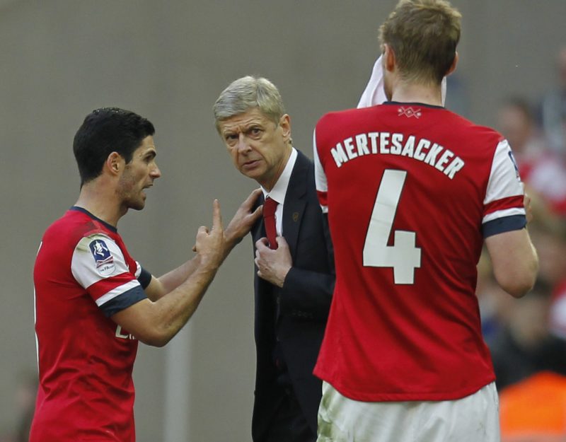 Arsenal's Spanish midfielder Mikel Arteta (L) gestures to Arsenal's French Manager Arsene Wenger during the English FA Cup Semi-final match between Wigan Athletic and Arsenal at Wembley Stadium in London on April 12, 2014. (Photo KINGTON/AFP via Getty Images)