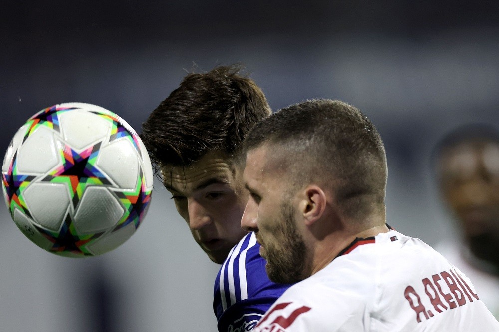 Zagreb's Croatian midfielder Martin Baturina (L) fights for the ball with AC Milan's Croatian forward Ante Rebic during the UEFA Champions League Group E football match between Dinamo Zagreb and AC Milan at the Maksimir Stadium in Zagreb on October 25, 2022. (Photo by DAMIR SENCAR/AFP via Getty Images)