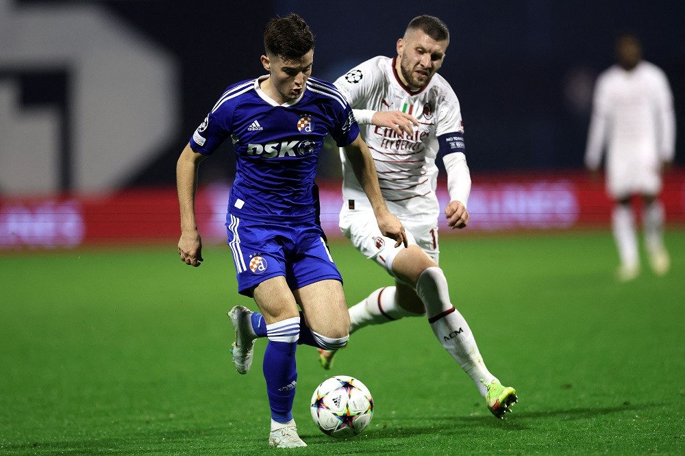 Zagreb's Croatian midfielder Martin Baturina (L) runs with the ball next to AC Milan's Croatian forward Ante Rebic during the UEFA Champions League Group E football match between Dinamo Zagreb and AC Milan at the Maksimir Stadium in Zagreb on October 25, 2022. (Photo by DAMIR SENCAR/AFP via Getty Images)