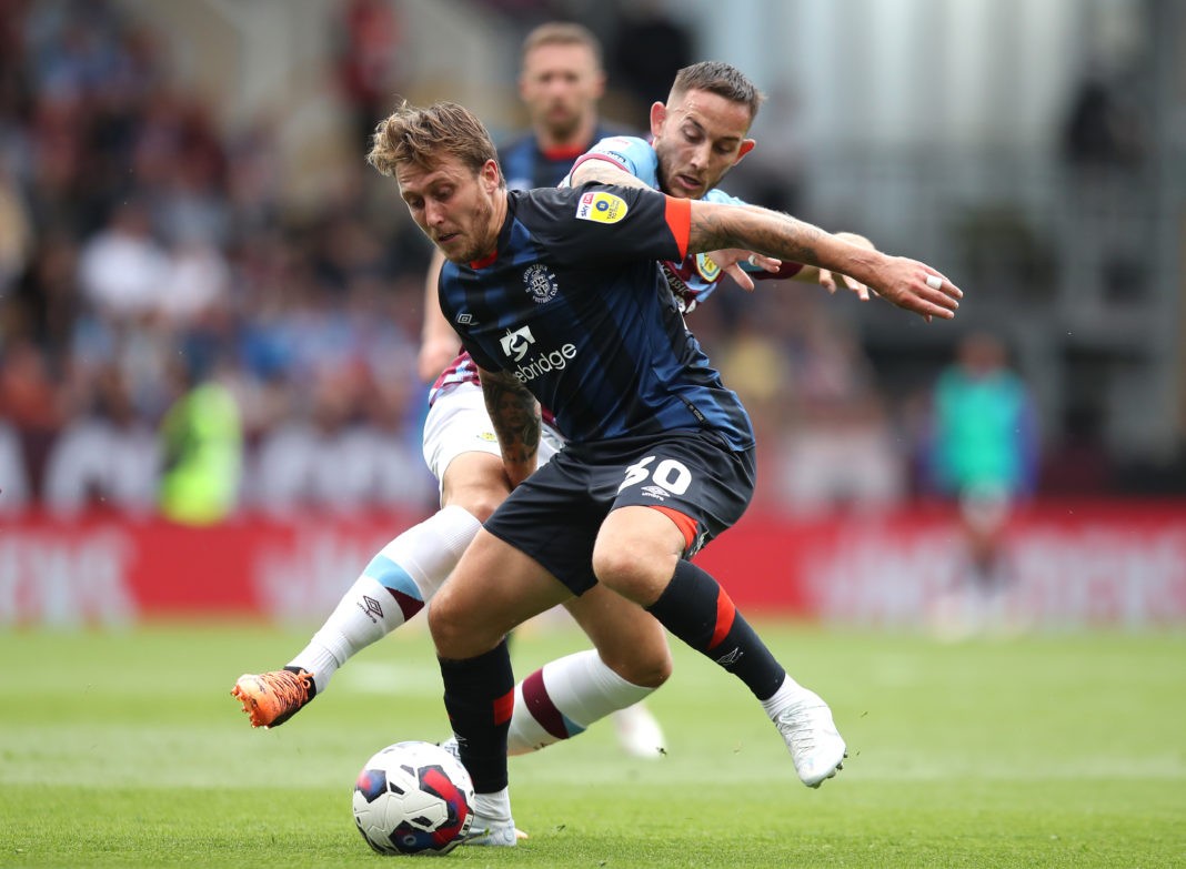 BURNLEY, ENGLAND - AUGUST 06: Luke Freeman of Luton Town keeps ball possession from Josh Brownhill of Burnley FC during the Sky Bet Championship match between Burnley and Luton Town at Turf Moor on August 06, 2022 in Burnley, England. (Photo by Ashley Allen/Getty Images)