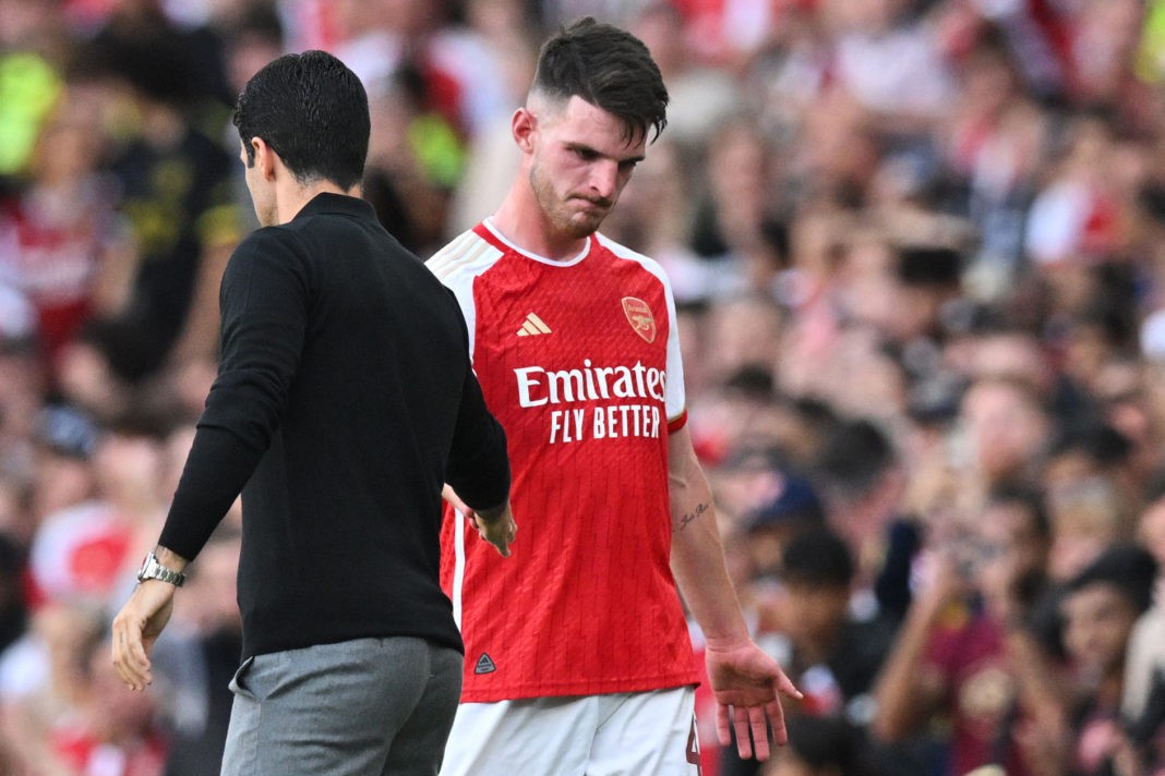Arsenal's Spanish manager Mikel Arteta (L) shakes hands with Arsenal's English midfielder Declan Rice as he leaves the pitch during the pre-season friendly football match for the Emirates Cup final between Arsenal and Monaco at The Emirates Stadium in north London on August 2, 2023. (Photo by GLYN KIRK/AFP via Getty Images)