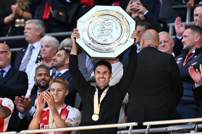 Arsenal's Spanish manager Mikel Arteta lifts the trophy after Arsenal win the shoot-out after the English FA Community Shield football match between Arsenal and Manchester City at Wembley Stadium, in London, August 6, 2023. Arsenal won after a 4-1 penalty shoot-out win, following the 1-1 draw in 90 minutes. (Photo by GLYN KIRK/AFP via Getty Images)