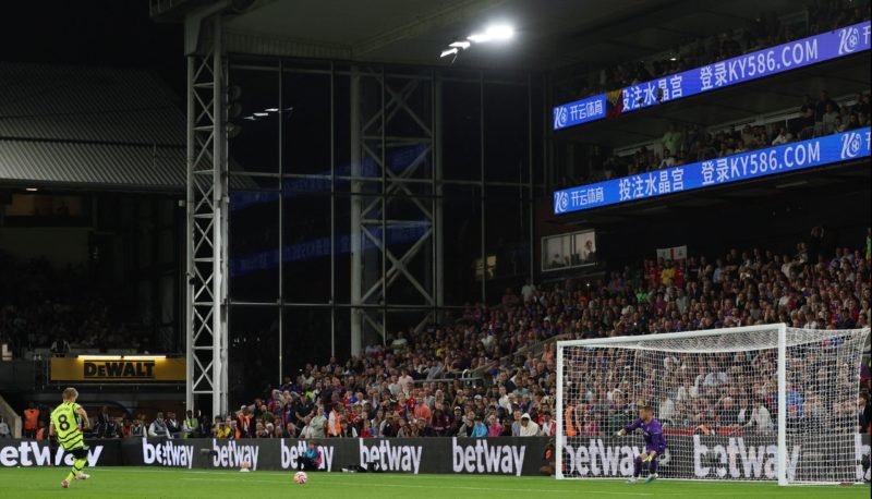 Arsenal's Norwegian midfielder #08 Martin Odegaard (L) shoots from the penalty spot to score his team's first goal during the English Premier League football match between Crystal Palace and Arsenal at Selhurst Park in south London on August 21, 2023. (Photo by ADRIAN DENNIS/AFP via Getty Images)