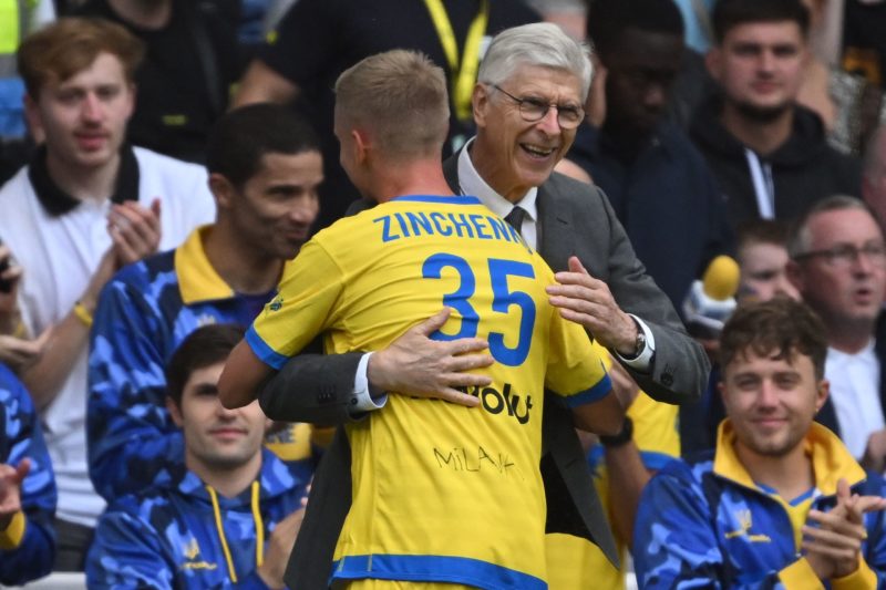 Team Yellow's captain, Ukrainian midfielder Oleksandr Zinchenko is congratulated by Team Yellow's German coach Arsene Wenger as he is substituted off during the Game4Ukraine fundraising football match between Oleksandr Zinchenko's team and Andriy Shevchenko's team at Stamford Bridge in London, on August 5, 2023. (Photo by JUSTIN TALLIS/AFP via Getty Images)