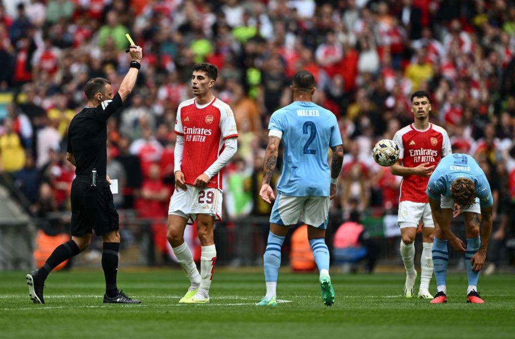 LONDON, ENGLAND - AUGUST 06: Kai Havertz of Arsenal is shown a yellow card by Referee Stuart Attwell during The FA Community Shield match between Manchester City against Arsenal at Wembley Stadium on August 06, 2023 in London, England. (Photo by Mike Hewitt/Getty Images)