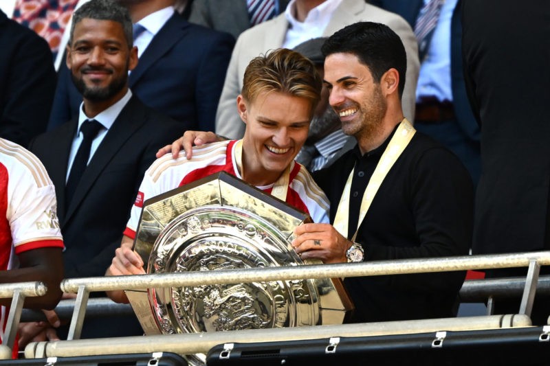 LONDON, ENGLAND - AUGUST 06: Martin Odegaard of Arsenal and Mikel Arteta, Manager of Arsenal hold the FA Community Shield following The FA Community Shield match between Manchester City against Arsenal at Wembley Stadium on August 06, 2023 in London, England. (Photo by Mike Hewitt/Getty Images)