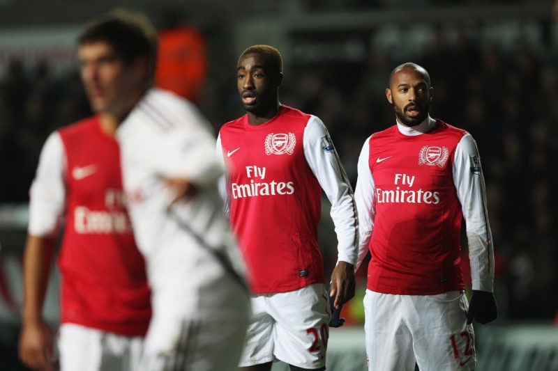SWANSEA, WALES - JANUARY 15:  Thierry Henry (R) of Arsenal looks on with Johan Djourou during the Barclays Premier League match between Swansea City and Arsenal at Liberty Stadium on January 15, 2012 in Swansea, Wales.  (Photo by Michael Steele/Getty Images)