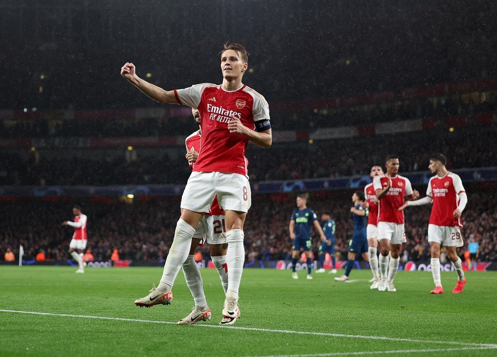 LONDON, ENGLAND: Martin Odegaard of Arsenal celebrates scoring the fourth goal during the UEFA Champions League match between Arsenal FC and PSV Eindhoven at Emirates Stadium on September 20, 2023. (Photo by Julian Finney/Getty Images)