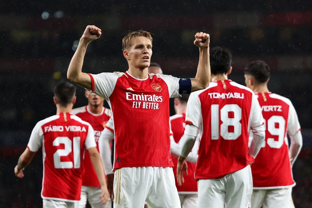LONDON, ENGLAND: Martin Oedegaard of Arsenal celebrates after scoring the team's fourth goal during the UEFA Champions League match between Arsenal FC and PSV Eindhoven at Emirates Stadium on September 20, 2023. (Photo by Julian Finney/Getty Images)