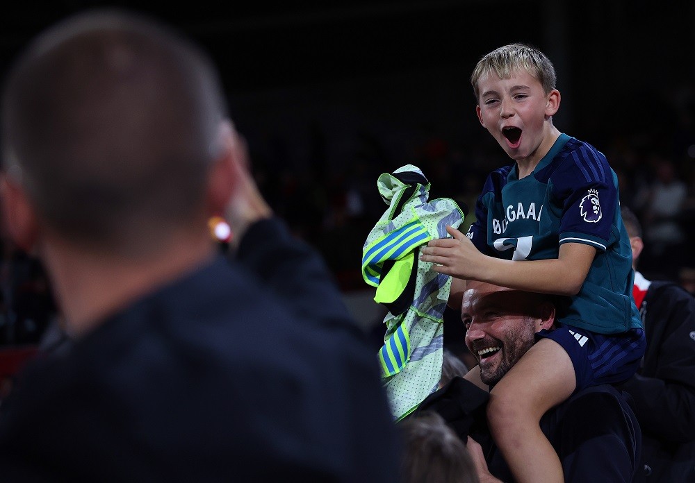 BRENTFORD, ENGLAND: An Arsenal fan reacts after Martin Odegaard of Arsenal gives him his shirt following the Carabao Cup Third Round match between Brentford and Arsenal at Gtech Community Stadium on September 27, 2023. (Photo by Julian Finney/Getty Images)