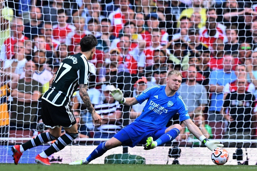 Manchester United's Argentinian midfielder Alejandro Garnacho scores past Arsenal's English goalkeeper Aaron Ramsdale (R) but after a VAR (Video Assistant Referee) the goal is disallowed for offside during the English Premier League football match between Arsenal and Manchester United at the Emirates Stadium in London on September 3, 2023. (Photo by GLYN KIRK/AFP via Getty Images)