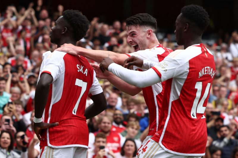 Arsenal's English midfielder #07 Bukayo Saka (L) with Arsenal's English midfielder #41 Declan Rice (C) and Arsenal's English striker #14 Eddie Nketiah celebrates scoring the team's second goal during the English Premier League football match between Arsenal and Nottingham Forest at the Emirates Stadium in London on August 12, 2023. (Photo by HENRY NICHOLLS/AFP via Getty Images)