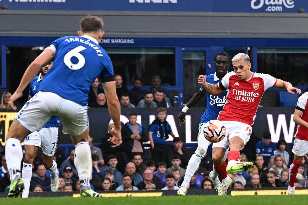 Arsenal's Belgian midfielder #19 Leandro Trossard (R) shoots to score the opening goal of the English Premier League football match between Everton and Arsenal at Goodison Park in Liverpool, north west England on September 17, 2023. (Photo by PAUL ELLIS/AFP via Getty Images)