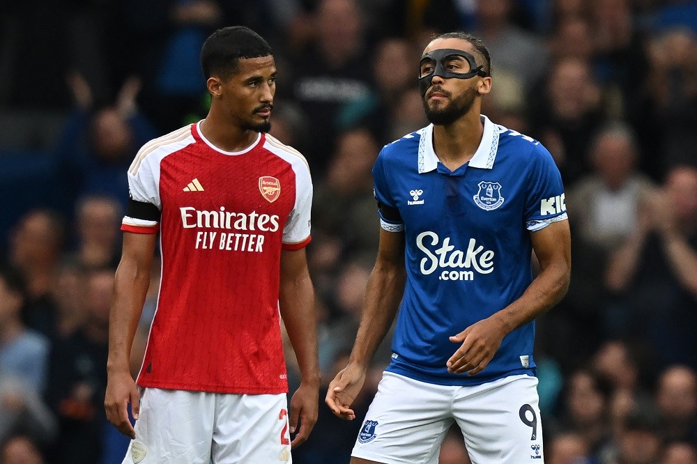 Arsenal's French defender #02 William Saliba (L) checks the facemask being worn by Everton's English striker #09 Dominic Calvert-Lewin (R) during the English Premier League football match between Everton and Arsenal at Goodison Park in Liverpool, north west England on September 17, 2023. (Photo by PAUL ELLIS/AFP via Getty Images)