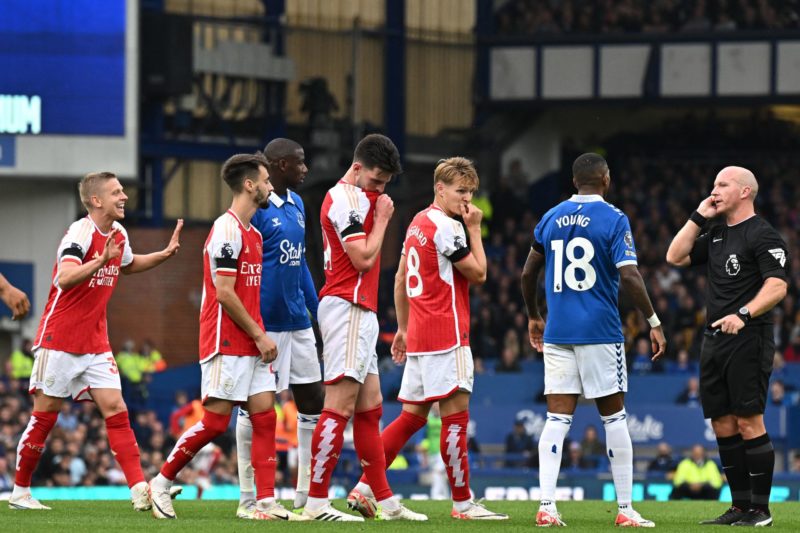 Players wait as English referee Simon Hooper (R) gets advice from the VAR (Video Assistant Referee) during the English Premier League football match between Everton and Arsenal at Goodison Park in Liverpool, north west England on September 17, 2023. (Photo by PAUL ELLIS/AFP via Getty Images)