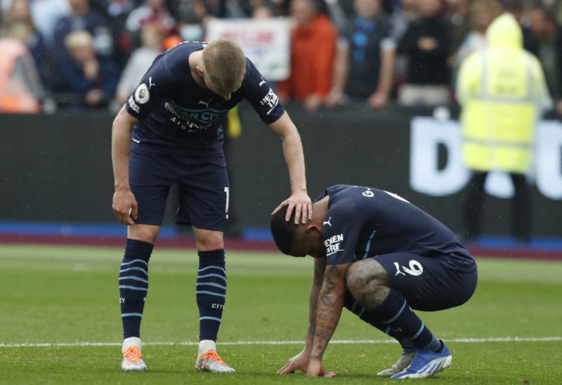 Manchester City's Ukrainian midfielder Oleksandr Zinchenko (L) and Manchester City's Brazilian striker Gabriel Jesus react at the end of the English Premier League football match between West Ham United and Manchester City at the London Stadium, in London on May 15, 2022. (Photo by IAN KINGTON/IKIMAGES/AFP via Getty Images)