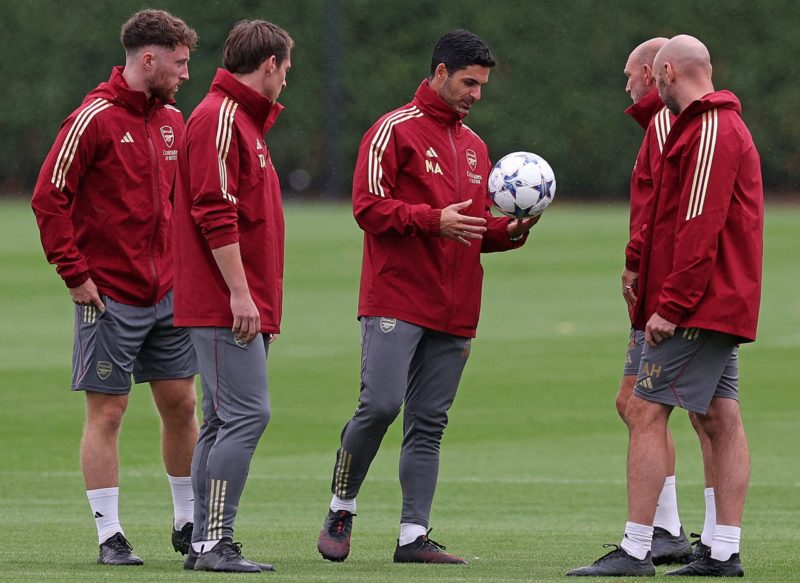 Arsenal's Spanish manager Mikel Arteta (C) looks at a Champions League ball during a team training session at Arsenal's training ground in north London on September 19, 2023, ahead of their UEFA Champions League Group B football match against PSV Eindhoven. (Photo by ADRIAN DENNIS/AFP via Getty Images)