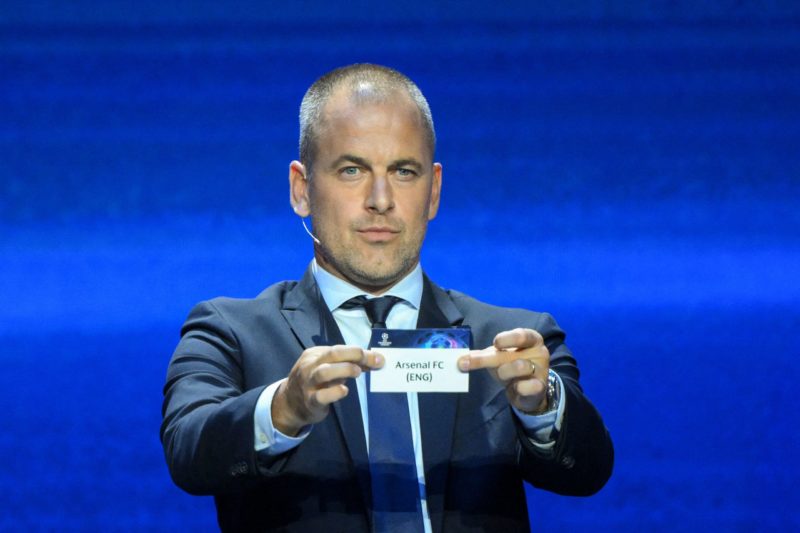 English former football player Joe Cole shows the paper slip of Arsenal FC during the draw for the 2023/2024 UEFA Champions League football tournament at The Grimaldi Forum in the Principality of Monaco, on August 31, 2023.  (Photo by NICOLAS TUCAT/AFP via Getty Images)
