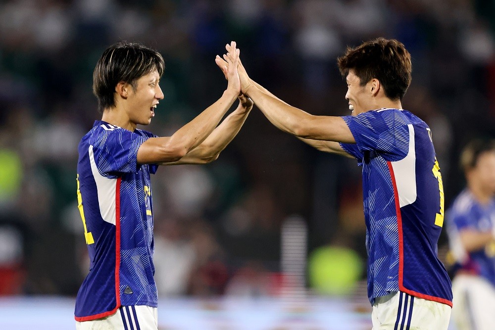 WOLFSBURG, GERMANY: Hiroki Ito and Takehiro Tomiyasu of Japan celebrate victory after the international friendly match between Germany and Japan at Volkswagen Arena on September 09, 2023. (Photo by Christof Koepsel/Getty Images)