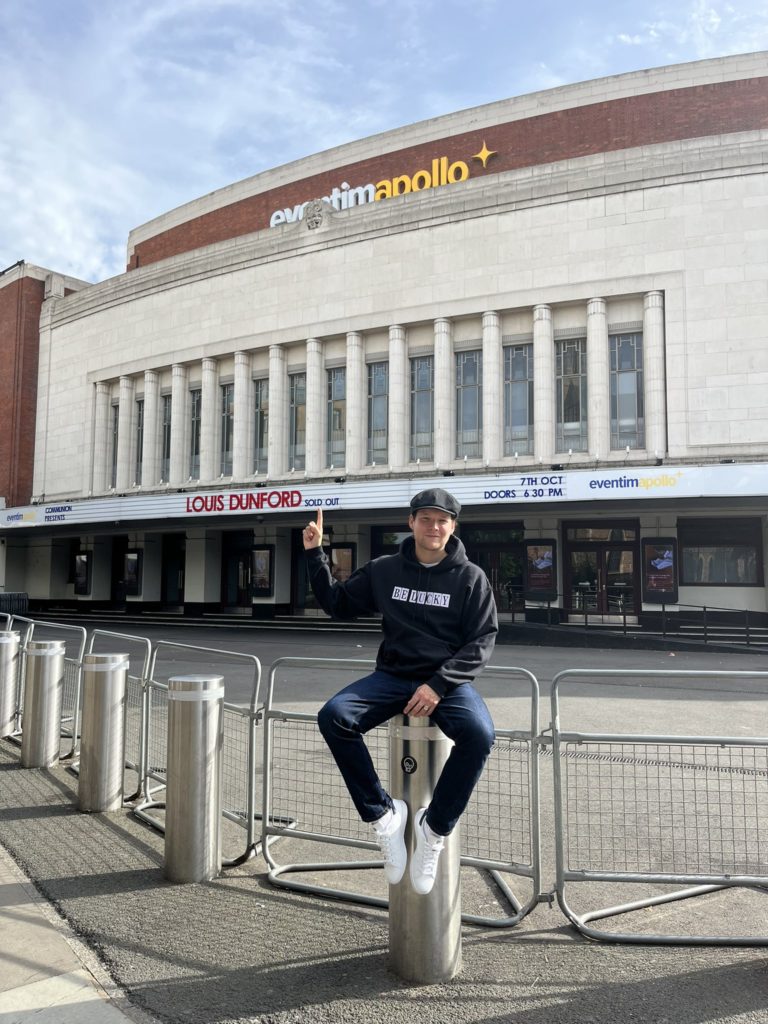 Louis Dunford sits in front of the Eventim Apollo (Photo via Dunford on Twitter)