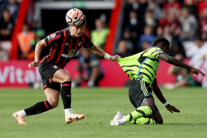 BOURNEMOUTH, ENGLAND - SEPTEMBER 30: Milos Kerkez of AFC Bournemouth challenges Bukayo Saka of Arsenal during the Premier League match between AFC Bournemouth and Arsenal FC at Vitality Stadium on September 30, 2023 in Bournemouth, England. (Photo by Christopher Lee/Getty Images)