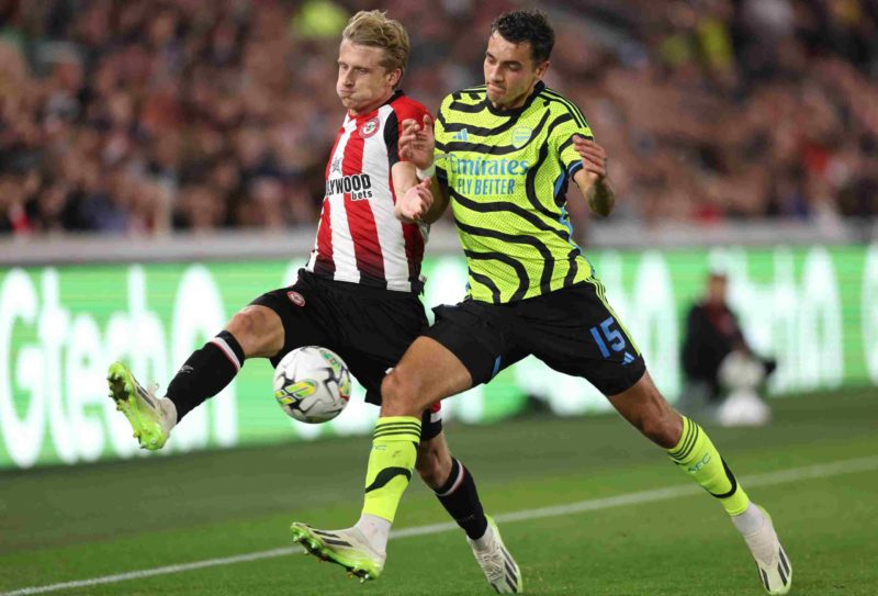 BRENTFORD, ENGLAND - SEPTEMBER 27: Mads Roerslev of Brentford is tackled by Jakub Kiwior of Arsenal during the Carabao Cup Third Round match between Brentford and Arsenal at Gtech Community Stadium on September 27, 2023 in Brentford, England. (Photo by Alex Pantling/Getty Images)