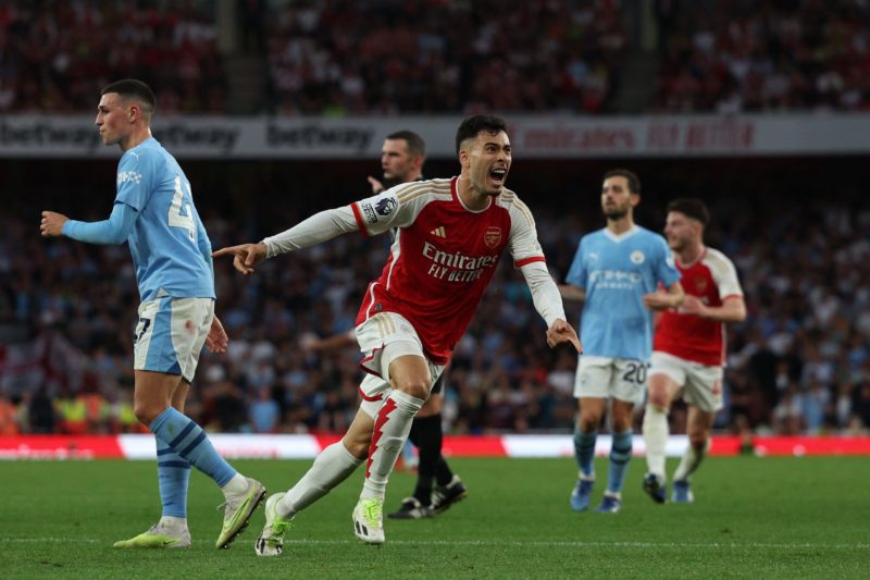 Arsenal's Brazilian midfielder #11 Gabriel Martinelli (C) celebrates after scoring the opening goal during the English Premier League football match between Arsenal and Manchester City at the Emirates Stadium in London on October 8, 2023. (Photo by ADRIAN DENNIS/AFP via Getty Images)