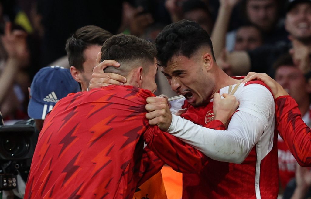 Arsenal's Brazilian midfielder #11 Gabriel Martinelli (R) celebrates with teammates after scoring the opening goal during the English Premier League football match between Arsenal and Manchester City at the Emirates Stadium in London on October 8, 2023. (Photo by ADRIAN DENNIS/AFP via Getty Images)