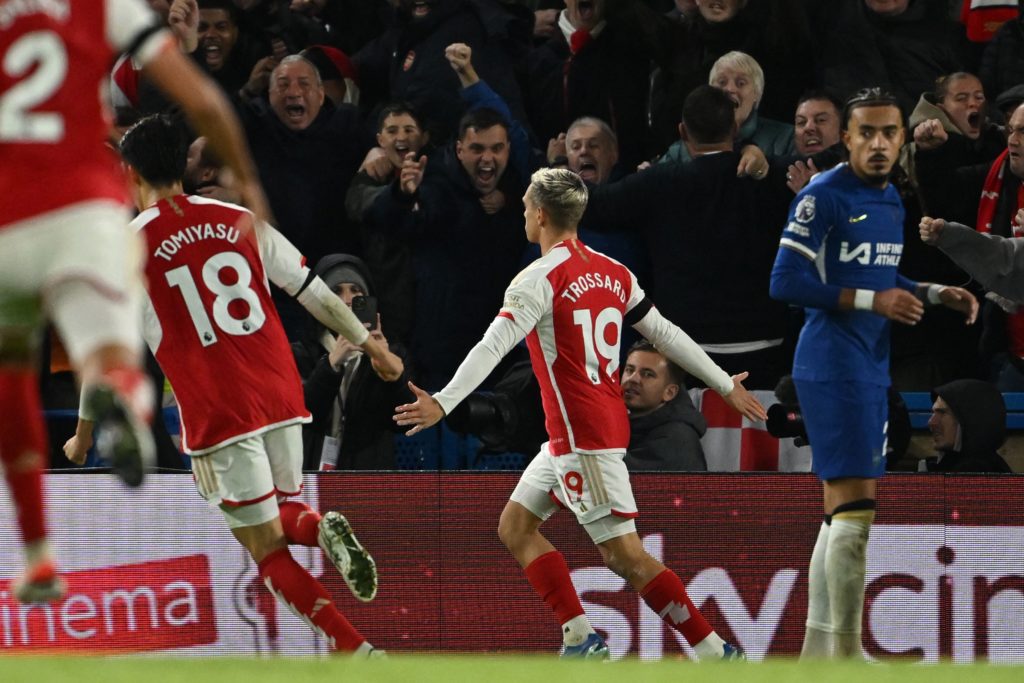 Arsenal's Belgian midfielder #19 Leandro Trossard (C) celebrates with teammates after scoring their second goal during the English Premier League football match between Chelsea and Arsenal at Stamford Bridge in London on October 21, 2023. (Photo by JUSTIN TALLIS/AFP via Getty Images)