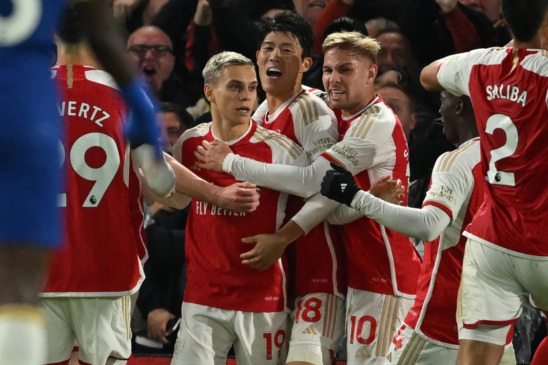 Arsenal's Belgian midfielder #19 Leandro Trossard (centre left) celebrates with teammates after scoring their second goal during the English Premier League football match between Chelsea and Arsenal at Stamford Bridge in London on October 21, 2023. (Photo by JUSTIN TALLIS/AFP via Getty Images)