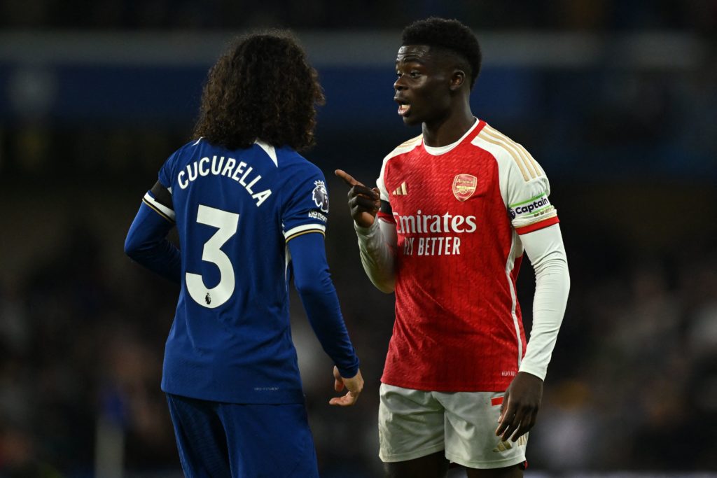 Chelsea's Spanish defender #03 Marc Cucurella (L) and Arsenal's English midfielder #07 Bukayo Saka (R) have words during the English Premier League football match between Chelsea and Arsenal at Stamford Bridge in London on October 21, 2023. (Photo by JUSTIN TALLIS/AFP via Getty Images)