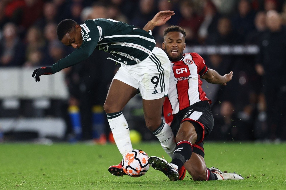 Manchester United's Anthony Martial (L) vies with Sheffield United's Auston Trusty (R) during the English Premier League football match between Sheffield United and Manchester United at Bramall Lane in Sheffield, northern England on October 21, 2023. (Photo by DARREN STAPLES/AFP via Getty Images)