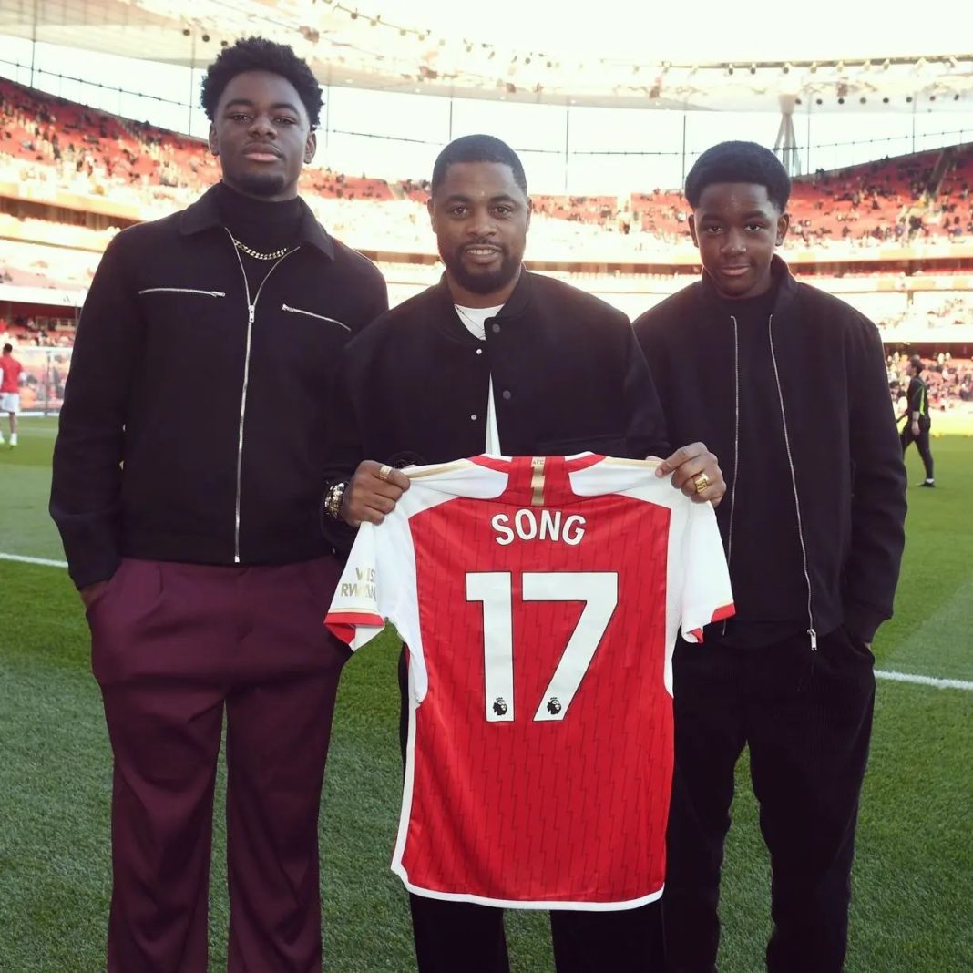 Alex Song holds up an Arsenal shirt with his name on it (Photo via Song on Instagram)