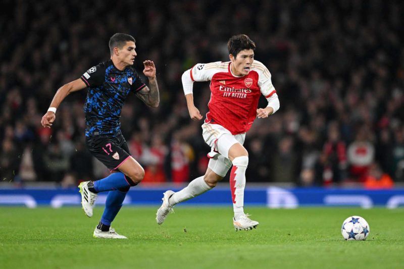 LONDON, ENGLAND - NOVEMBER 08: Takehiro Tomiyasu of Arsenal (R) and Erik Lamela of Sevilla FC battle for the ball during the UEFA Champions League match between Arsenal FC and Sevilla FC at Emirates Stadium on November 08, 2023 in London, England. (Photo by Shaun Botterill/Getty Images)
