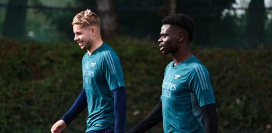 Arsenal's Emile Smith Rowe (L) and Bukayo Saka arrive to attend a team training session at Arsenal's training ground in north London on October 23, 2023, ahead of their UEFA Champions League Group B football match against Sevilla FC. (Photo by HENRY NICHOLLS/AFP via Getty Images)