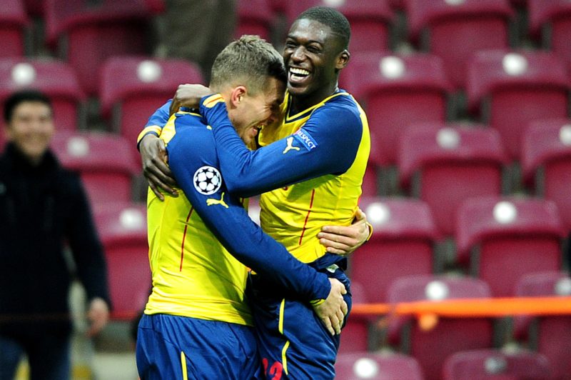 Arsenal's Lucas Podolski (L) celebrates with his teammate Yaya Sanogo (R) after scoring a fourth goal against Galatasaray during the UEFA Champions League group D football match Galatasaray vs Arsenal at TT Arena Stadium on December 9, 2014 in Istanbul. (Photo credit OZAN KOSE/AFP via Getty Images)