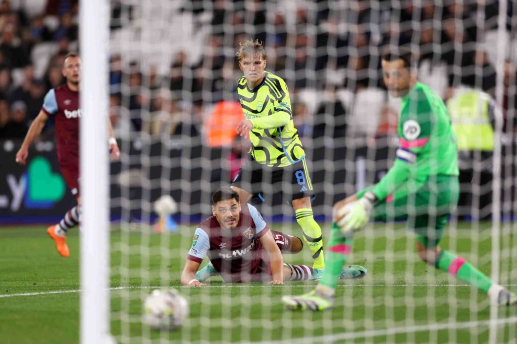 LONDON, ENGLAND - NOVEMBER 01: Martin Odegaard of Arsenal scores their sides first goal during the Carabao Cup Fourth Round match between West Ham United and Arsenal at London Stadium on November 01, 2023 in London, England. (Photo by Alex Pantling/Getty Images)