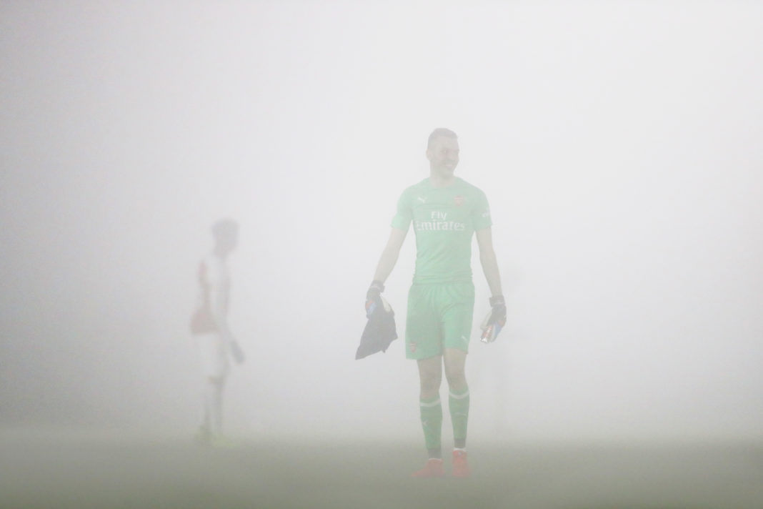 BOREHAMWOOD, ENGLAND - FEBRUARY 04: Dejan Iliev of Arsenal looks through the fog while the match is discussed as being postponed due to the thick fog during the Premier League 2 match between Arsenal and West Ham at Meadow Park on February 4, 2019 in Borehamwood, England. (Photo by Naomi Baker/Getty Images)