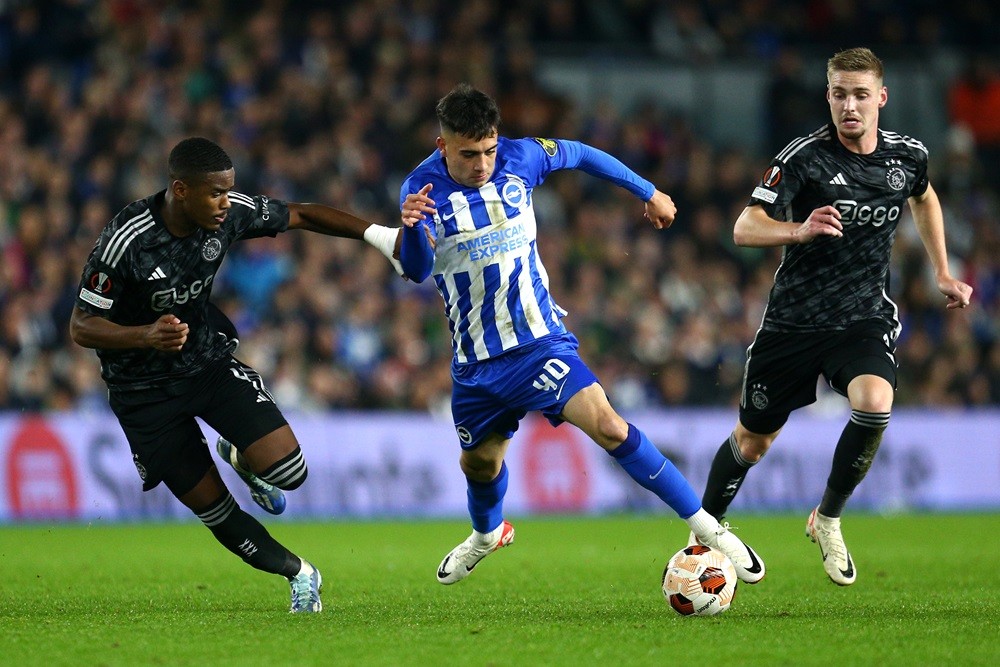 BRIGHTON, ENGLAND: Facundo Buonanotte of Brighton & Hove Albion is challenged by Jorrel Hato and Kenneth Taylor of Ajax during the UEFA Europa League 2023/24 match between Brighton & Hove Albion and AFC Ajax at American Express Community Stadium on October 26, 2023. (Photo by Charlie Crowhurst/Getty Images)