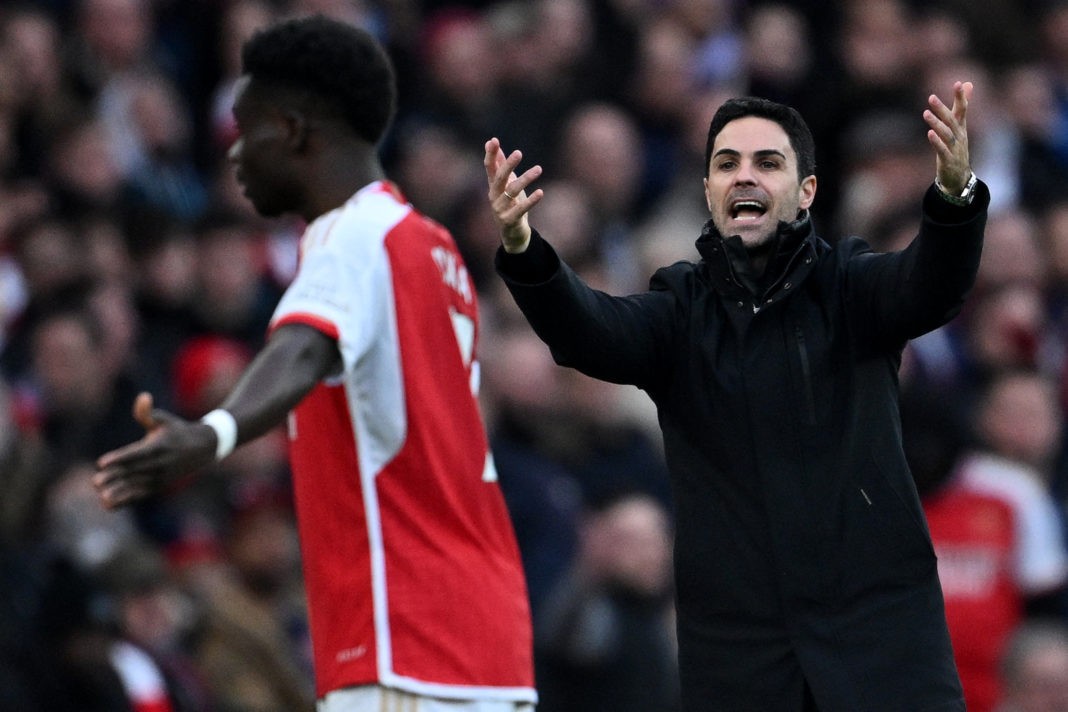 Arsenal's English midfielder #07 Bukayo Saka (L) and Arsenal's Spanish manager Mikel Arteta gesture during the English Premier League football match between Arsenal and Brighton and Hove Albion at the Emirates Stadium in London on December 17, 2023. (Photo by JUSTIN TALLIS/AFP via Getty Images)